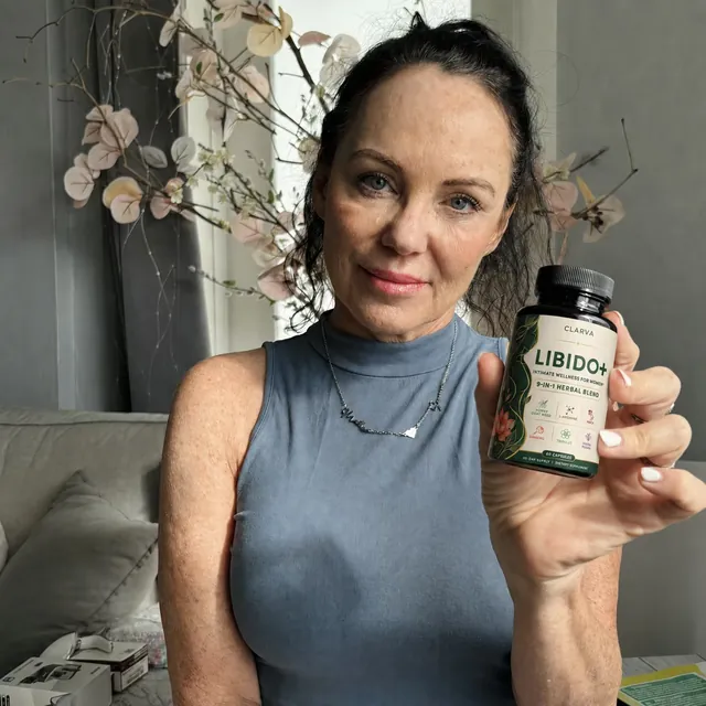 A person holding a CLARVA LIBIDO+ bottle