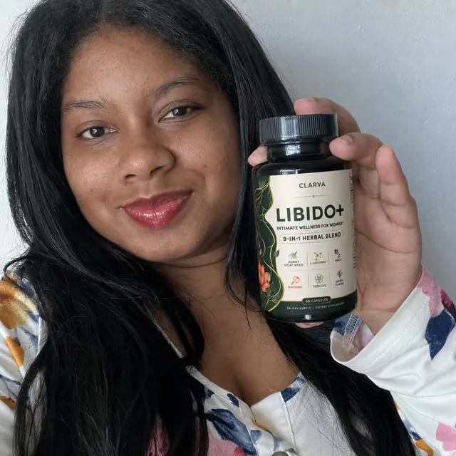 A person holding a CLARVA LIBIDO+ bottle